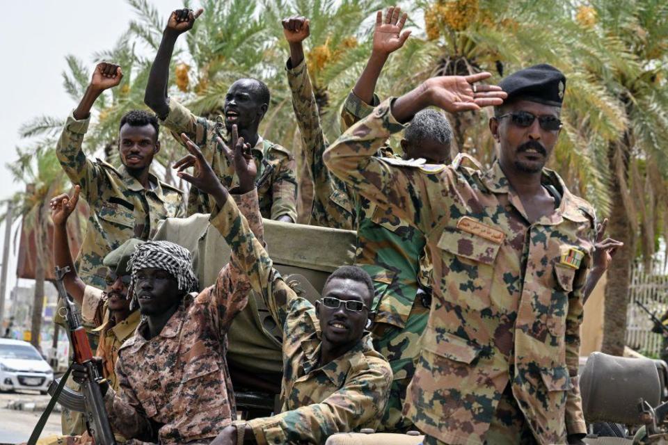 Members of Sudan's armed forces take part in a military parade held on the occasion of Army Day outside the Armed Forces Officers' Club in Port Sudan on 14 August.