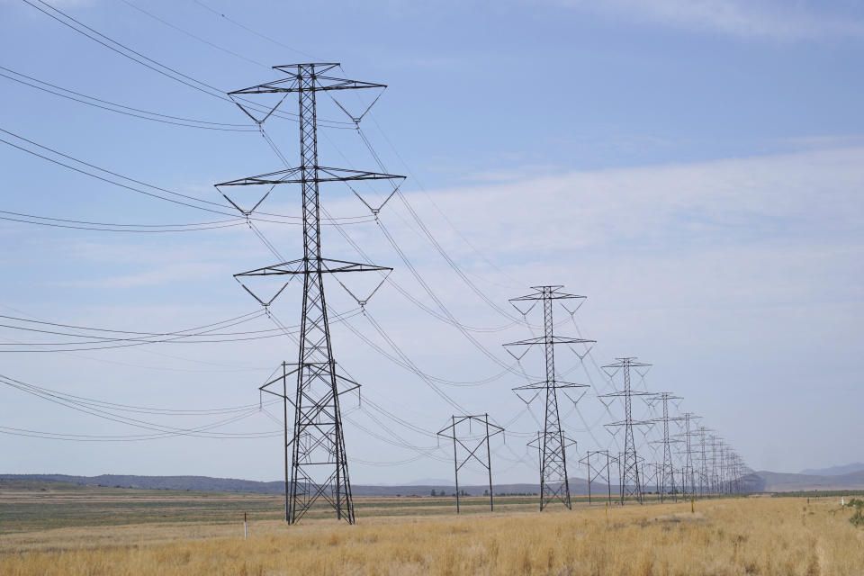 Large electrical transmission lines run through grass lands to power the newly completed Meta's Facebook data center in Eagle Mountain, Utah on July 18, 2024. The data center is a complex of five large buildings each over four football fields long and totaling 2.4 million square feet. (Photo by GEORGE FREY / AFP) (Photo by GEORGE FREY/AFP via Getty Images)