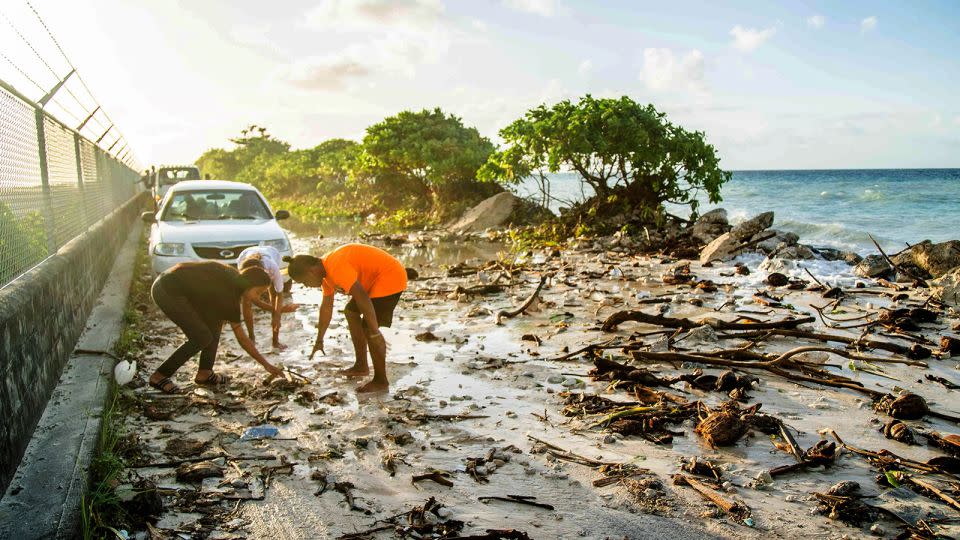 High-tide flooding and debris covers the road to the airport in the Marshall Islands capital Majuro on December 6, 2021. - Chewy Lin/AFP/Getty Images/File