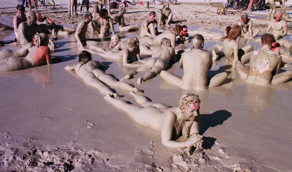 Participants at the festival frolic in the mud baths in the Black Rock Desert in September 1998. 