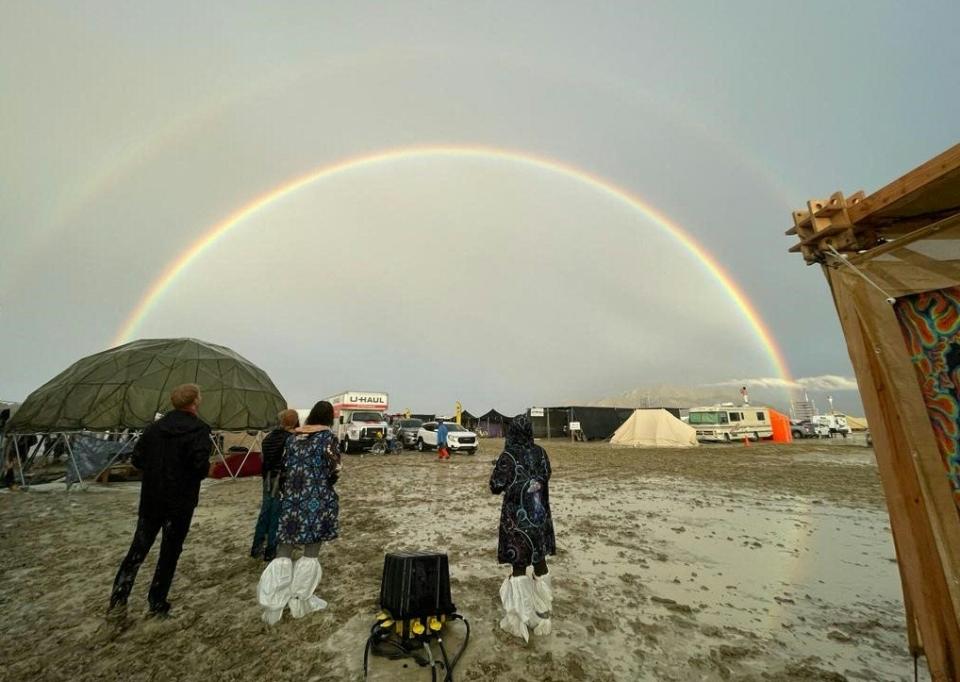 Attendees look at a double rainbow on Sept. 1, 2023, after heavy rains at the Burning Man festival site.