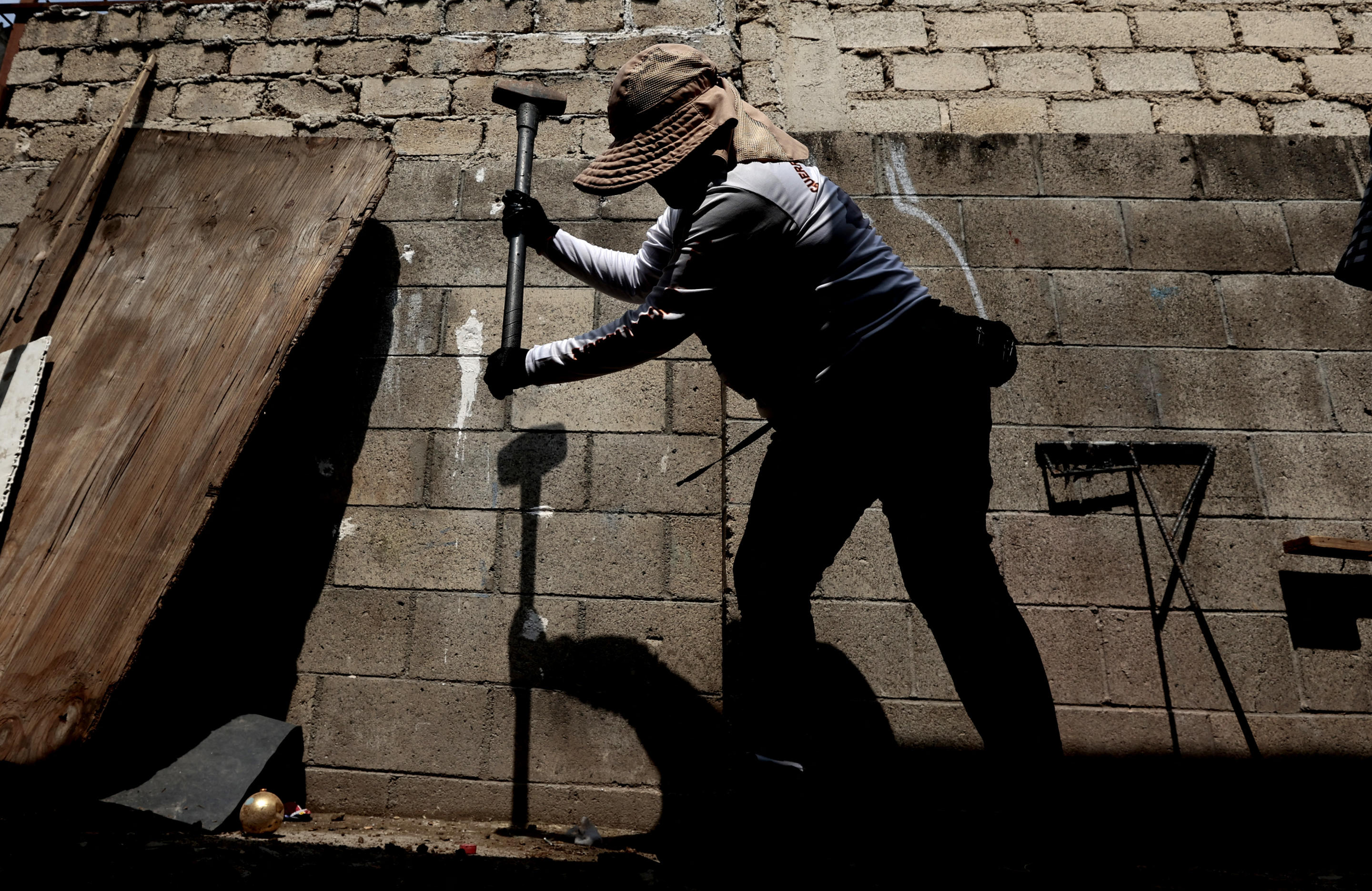 A female member of the collective Guerreros Buscadores searches for their missing relatives in Jalisco, Mexico, on Aug. 27. 