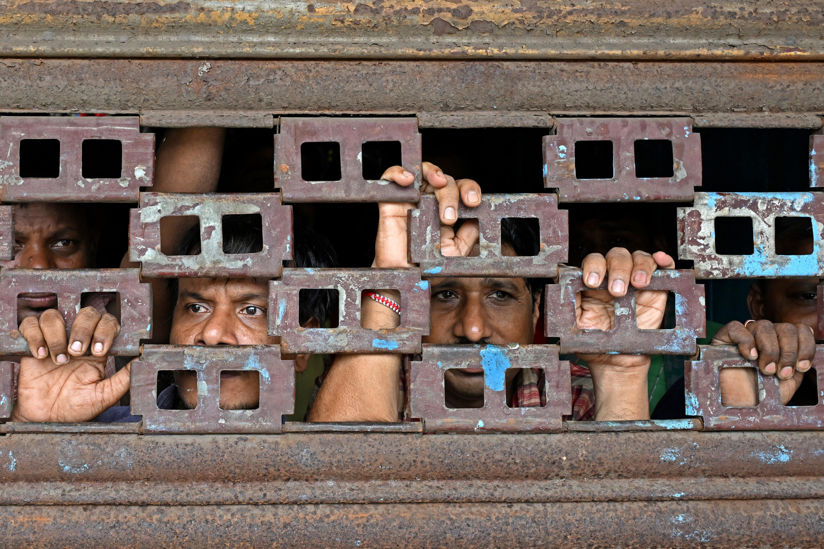 People watch as activists march to demand the resignation of Mamata Banerjee, chief minister of India's West Bengal state, in Kolkata on Aug. 27.