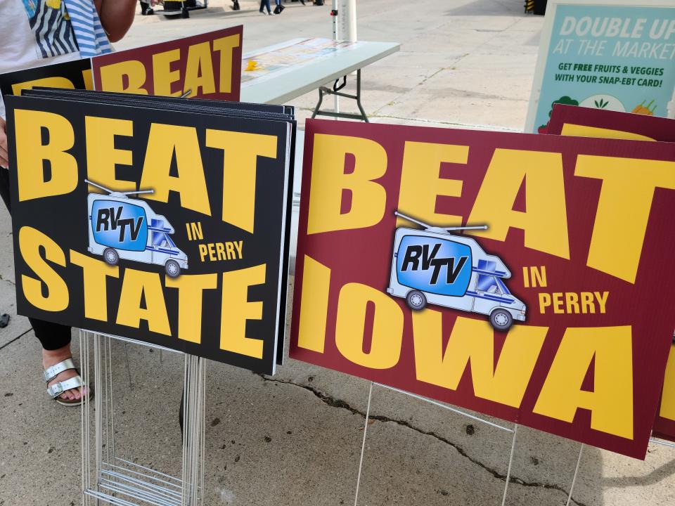 Iowa and Iowa State yard signs are pictured for sale at the Perry Farmers Market to help promote the RVTV Perry Tailgate, which will be held on Monday, Sept. 2 in downtown Perry.