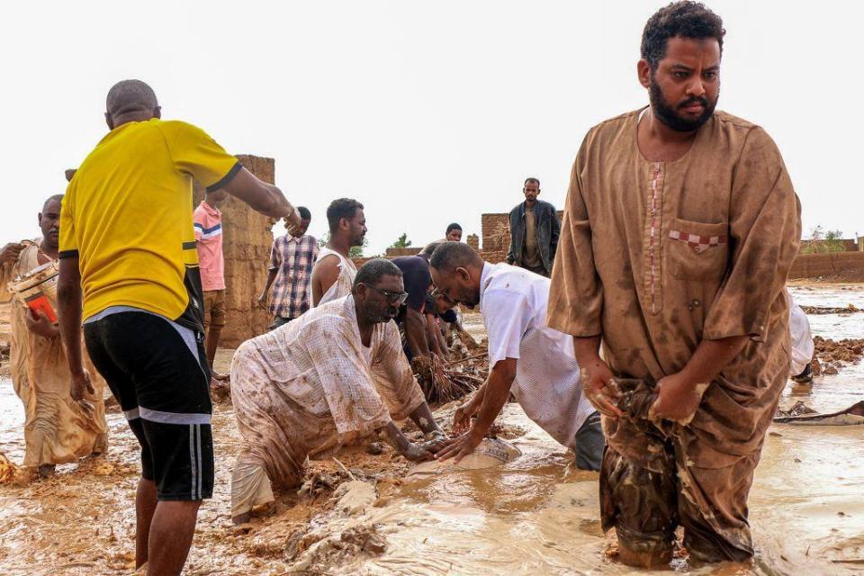 Men create a make-shift levee out of mudbrick amidst flooding in the area of Messawi near Meroe.