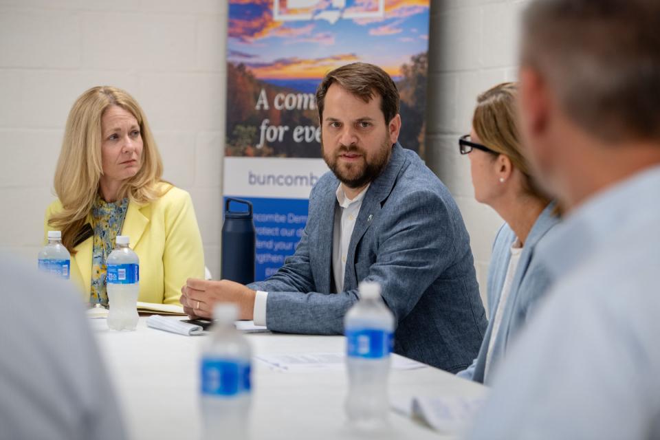 Amanda Edwards, left, and Mayor Esther Manheimer, right, listen as Parker Sloan speaks during a roundtable, August 29, 2024.