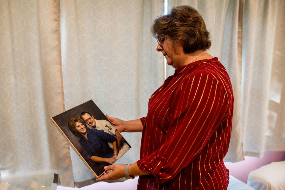 Ann Faucette holds a portrait of her and her husband. (Rosem Morton for NBC News)