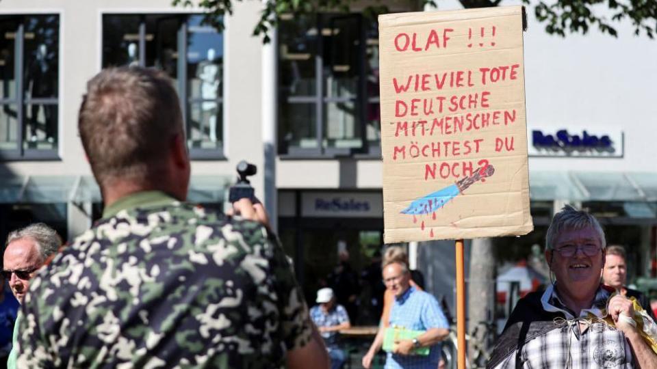 People attend a protest following a stabbing rampage in Solingen in which several individuals were killed and injured, as German Chancellor Olaf Scholz visits a Social Democratic Party (SPD) election campaign rally, in Jena, Germany, August 27, 2024.