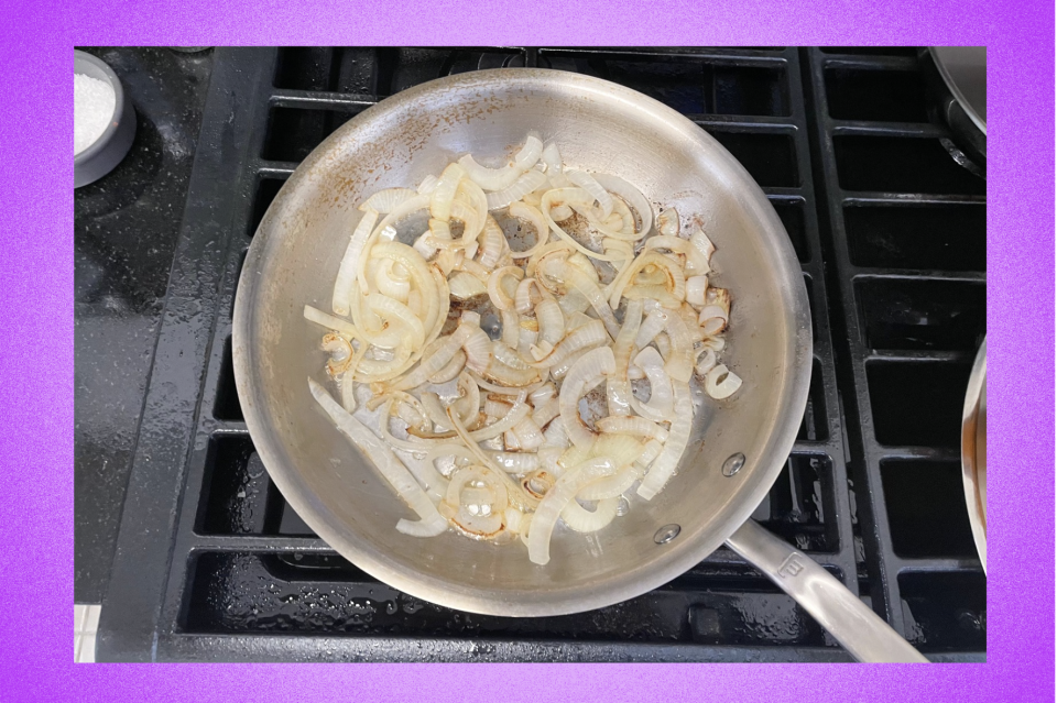 Stainless Steel Pan with sauteed onions on stovetop