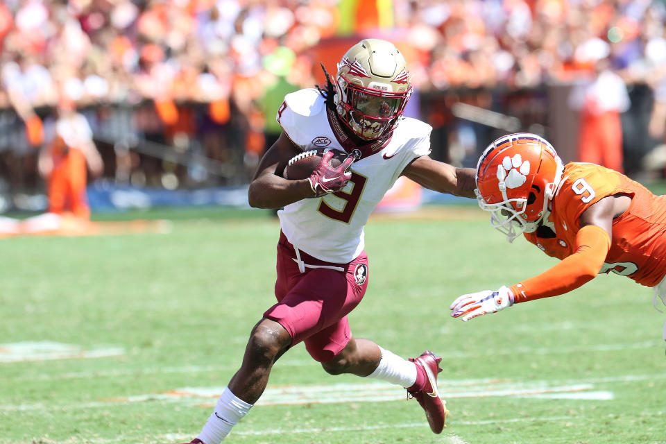 CLEMSON, SC - SEPTEMBER 23: Florida State Seminoles running back Lawrance Toafili (9) gives a stiff arm to Clemson Tigers safety R.J. Mickens (9) during a college football game between the Florida State Seminoles and the Clemson Tigers on September 23, 2023, at Clemson Memorial Stadium in Clemson, S.C.  (Photo by John Byrum/Icon Sportswire via Getty Images)