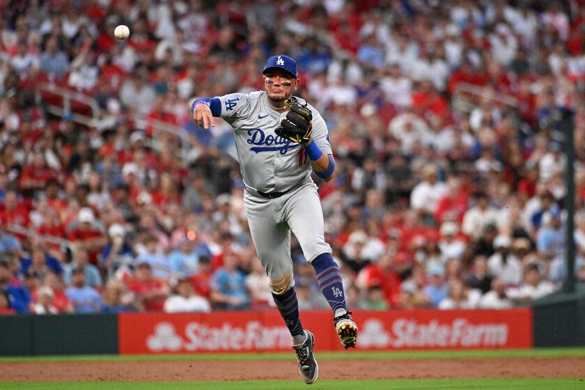 ST LOUIS, MISSOURI - AUGUST 16: Miguel Rojas #11 of the Los Angeles Dodgers throws to first base.