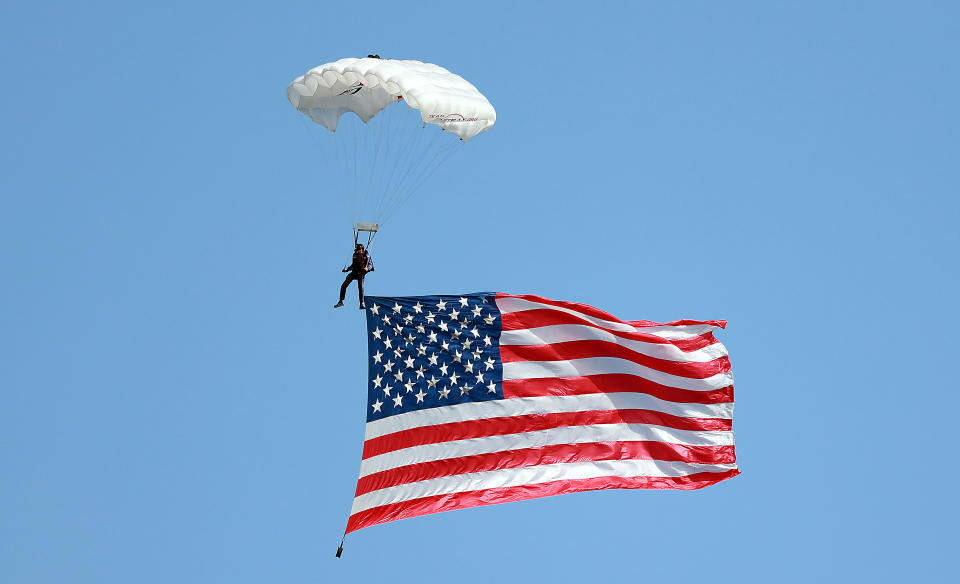 GRAND BLANC,MICHIGAN-AUGUST 23: A parachutist flies the American flag over the 18th hole during the Folds of Honor Closing Ceremony during the first round of The Ally Challenge presented by McLaren at Warwick Hills Golf & Country Club, Grand Blanc, MI, USA Friday, August 23, 2024. (Photo by Amy Lemus/NurPhoto via Getty Images)