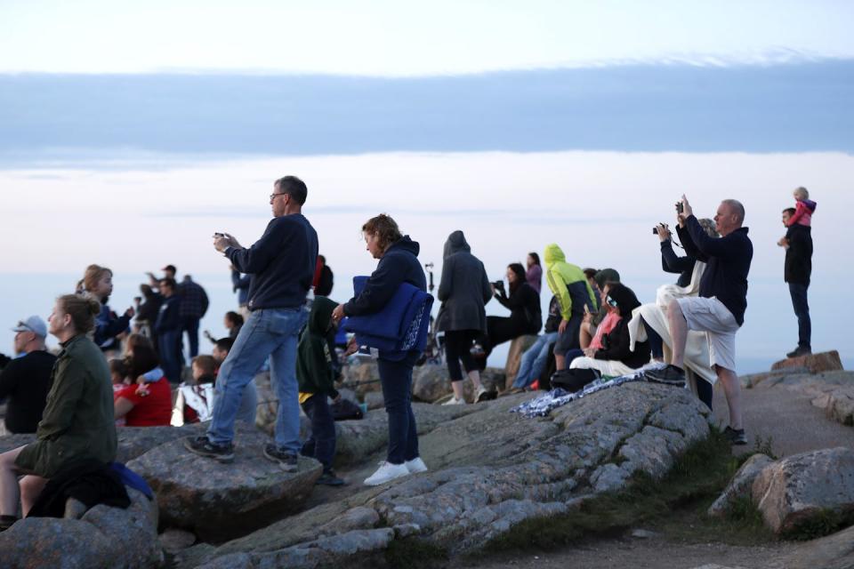 People with cameras, looking out to sea