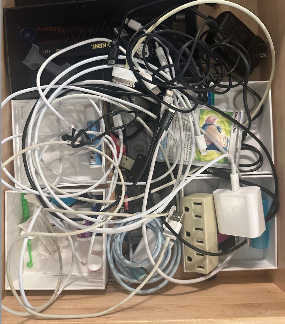 Several tangled cords in a drawer.