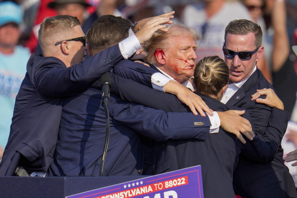 Donald Trump is surrounded by U.S. Secret Service agents. (Gene J. Puskar / AP file)