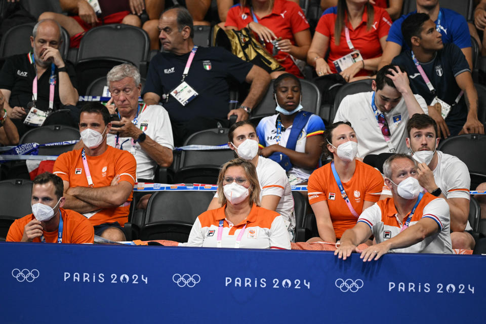 Coaches from the Netherlands wearing face masks attend the swimming event during the 2024 Paris Olympics on July 31.