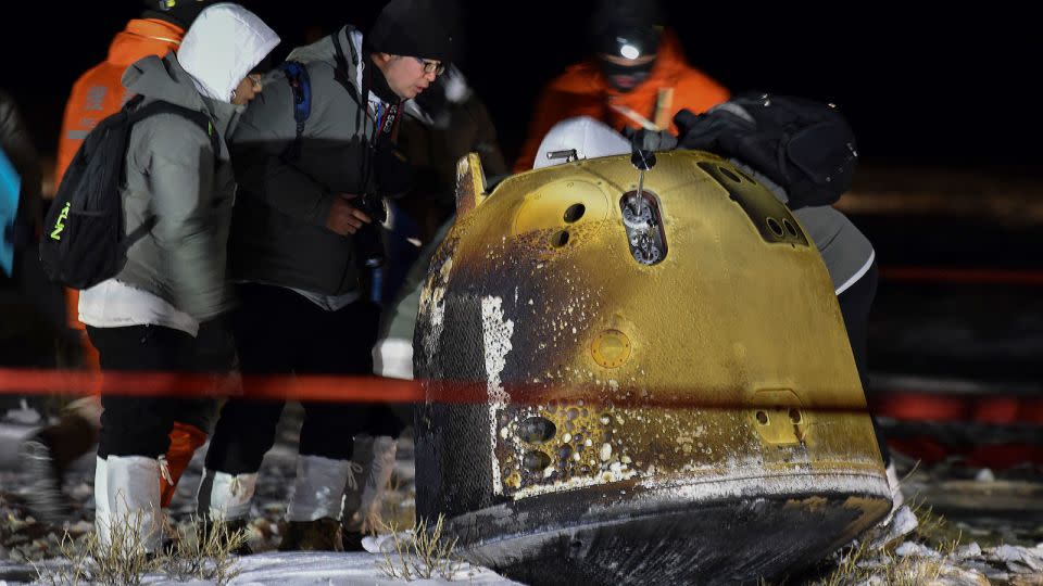 Recovery crew members inspect the Chang'e 5 probe after its successful return landing in northern China in December 2020. - Ren Junchuan/Xinhua/AP/File