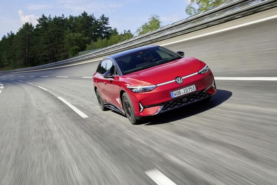 a red car driving on a road