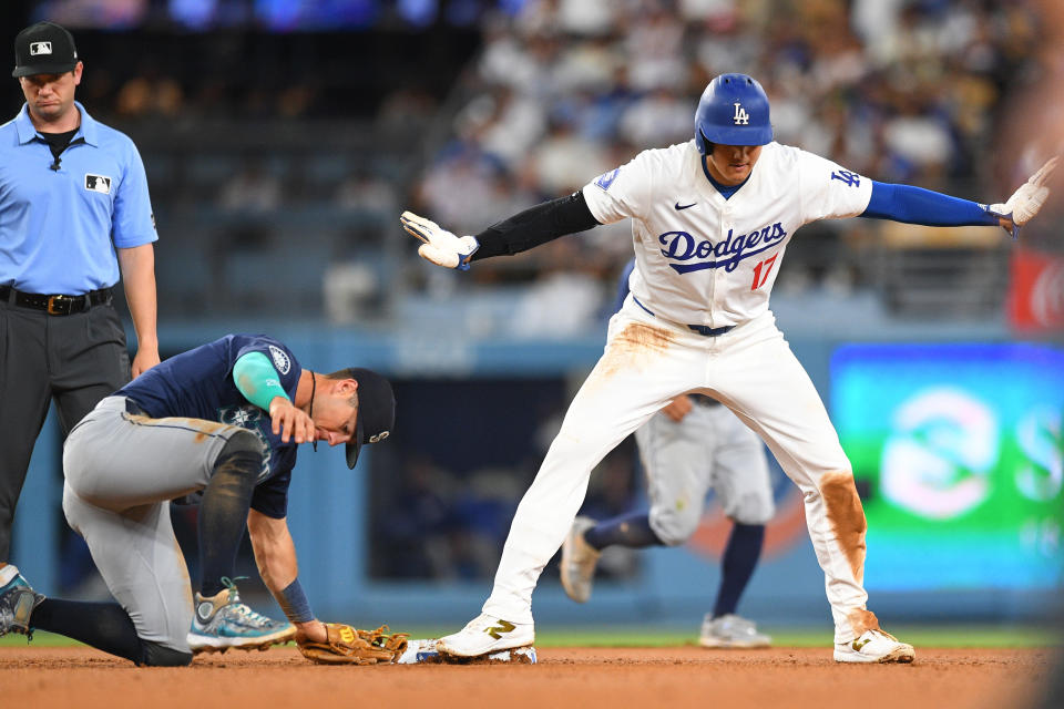 Dodgers designated hitter Shohei Ohtani slides safely into second base before the tag from Seattle Mariners second baseman Dylan Moore for a stolen base. (Photo by Brian Rothmuller/Icon Sportswire via Getty Images)