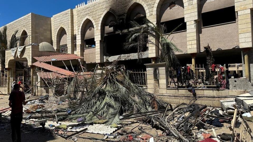 Palestinians look at damages at the site of an Israeli strike on a school sheltering displaced people, amid the Israel-Hamas conflict, in Gaza City August 10, 2024