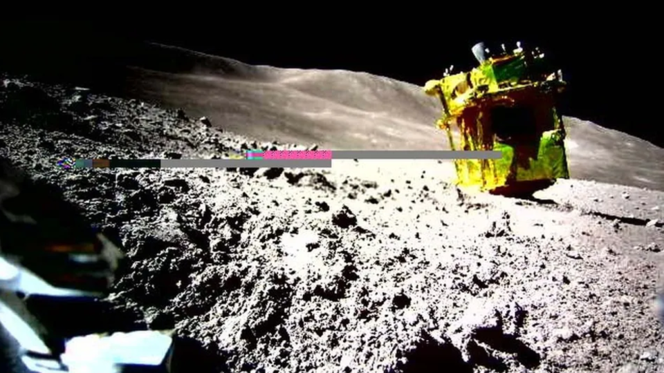  A yellow-wrapped spacecraft is upside down on the moon. 