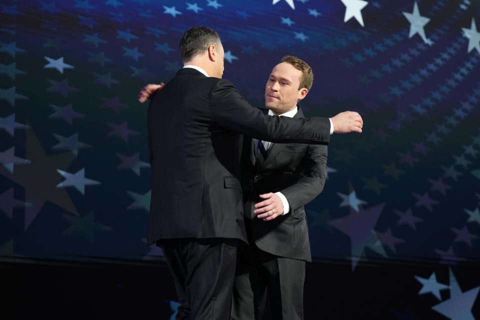 Cole Emhoff hugs his dad on the second day of the Democratic National Convention.