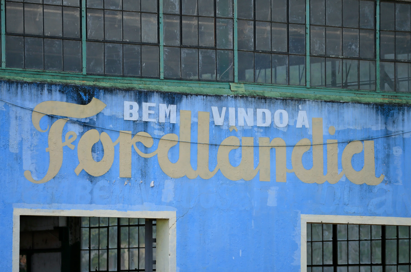 A welcome sign on the side of an abandoned factory building near the Fordlandia harbor on July 5, 2017 in Aveiro, Brazil. American industrialist Henry Ford negotiated the rights to 2.5 million acres of land from the Brazilian government to establish a rubber plantation. Construction started in 1926 with the hopes of employing 10,000 workers. By 1945 the project was considered a failure and the land was given back to the Brazilian government. - Photo: Joel Auerbach (Getty Images)
