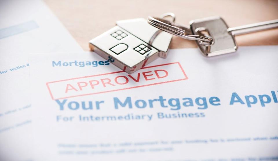 approved mortgage application document with house key