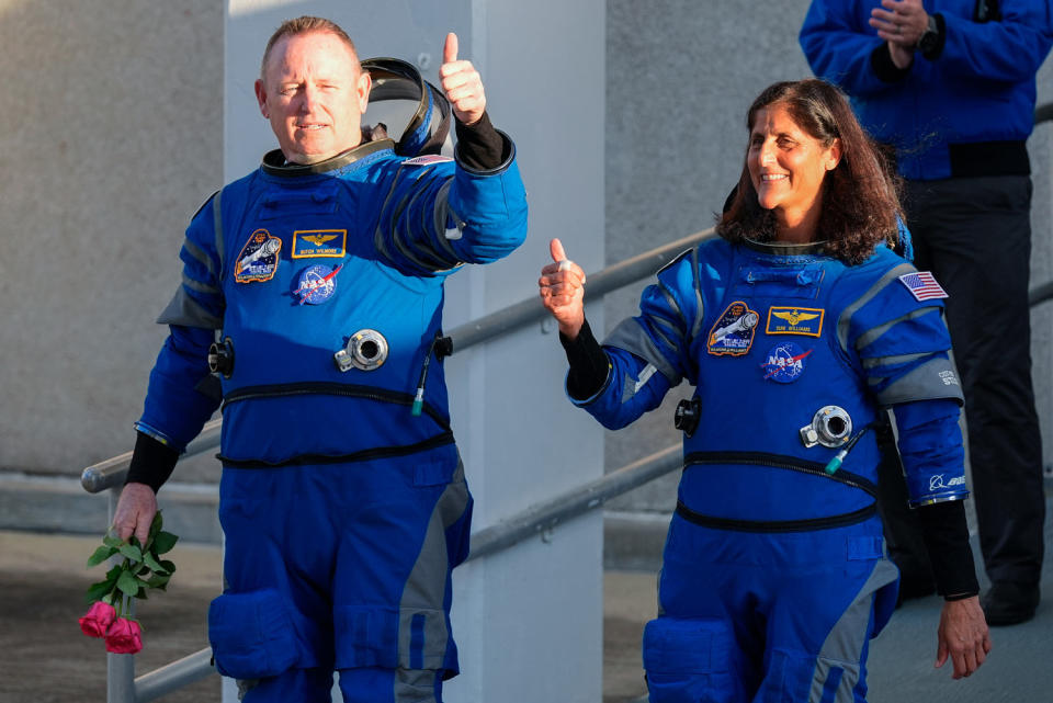 Butch Wilmore, left, and Suni Williams in their space suits give thumbs up (John Raoux / AP file)