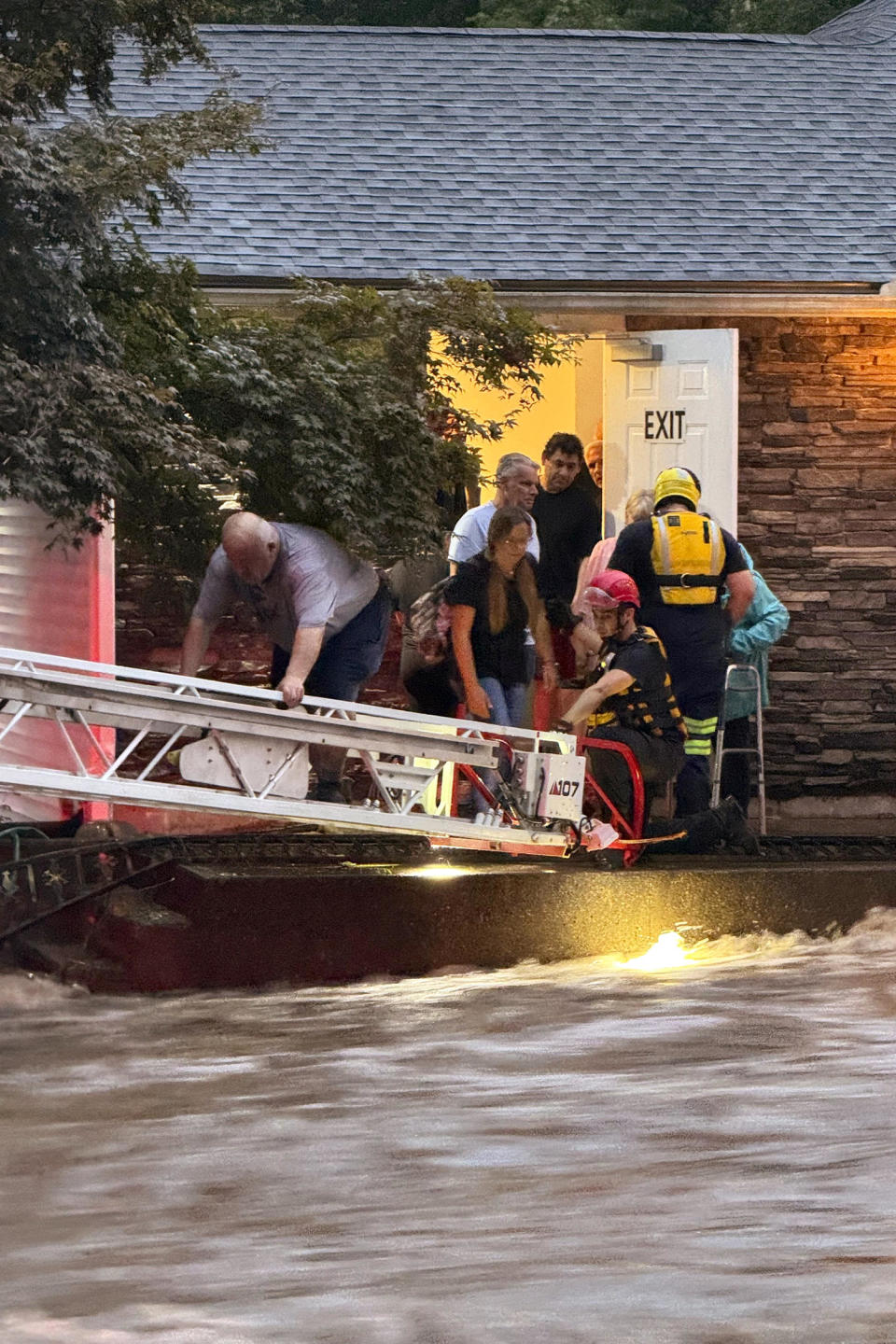 Image: firefighter flood rescue ladder (Beacon Hose Co via AP)