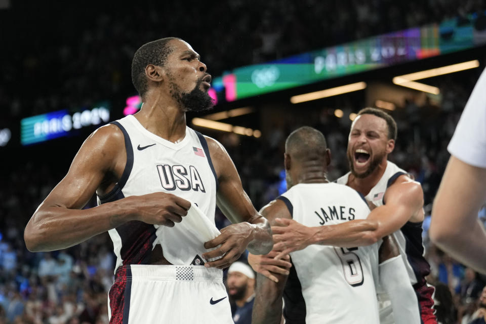 Kevin Durant, LeBron James and Steph Curry revel in a well-earned victory. (AP Photo/Mark J. Terrill)