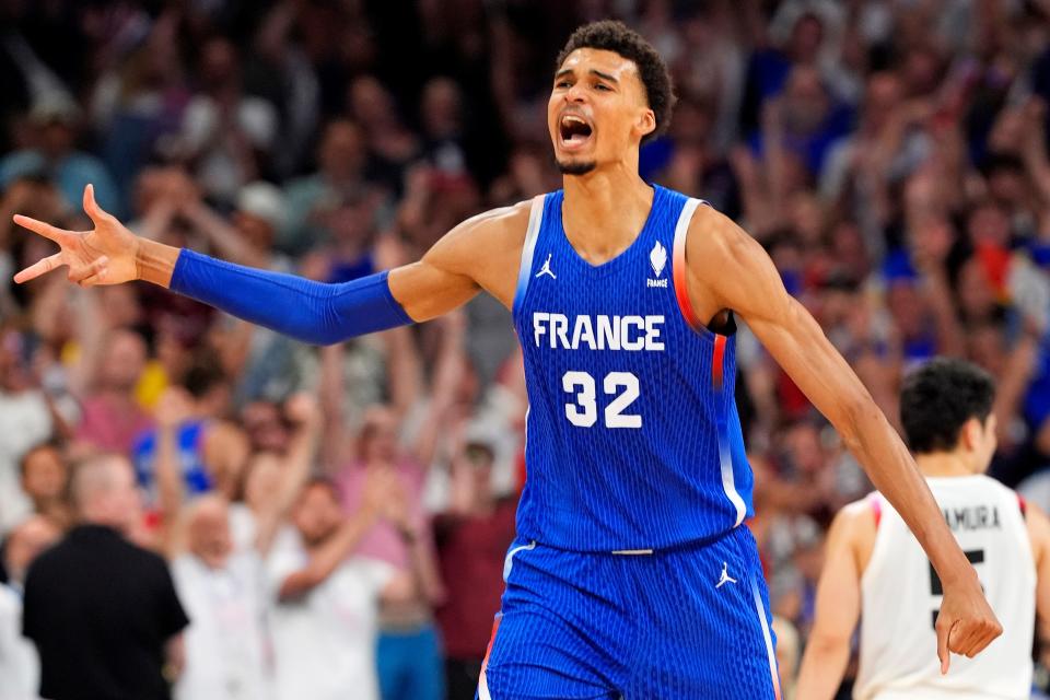 France power forward Victor Wembanyama celebrates after defeating Japan in men’s basketball group B play during the Paris Olympics.