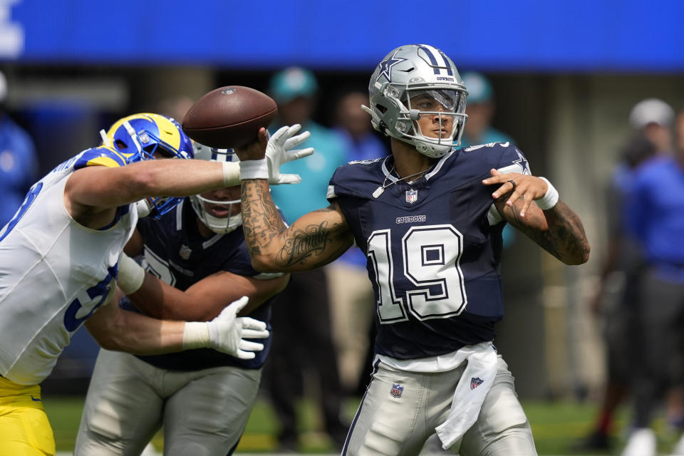 Dallas Cowboys quarterback Trey Lance (19) throws a pass under pressure from Los Angeles Rams linebacker Zach VanValkenburg, left, during the first half of a preseason NFL football game, Sunday, Aug. 11, 2024, in Inglewood, Calif. (AP Photo/Ryan Sun)