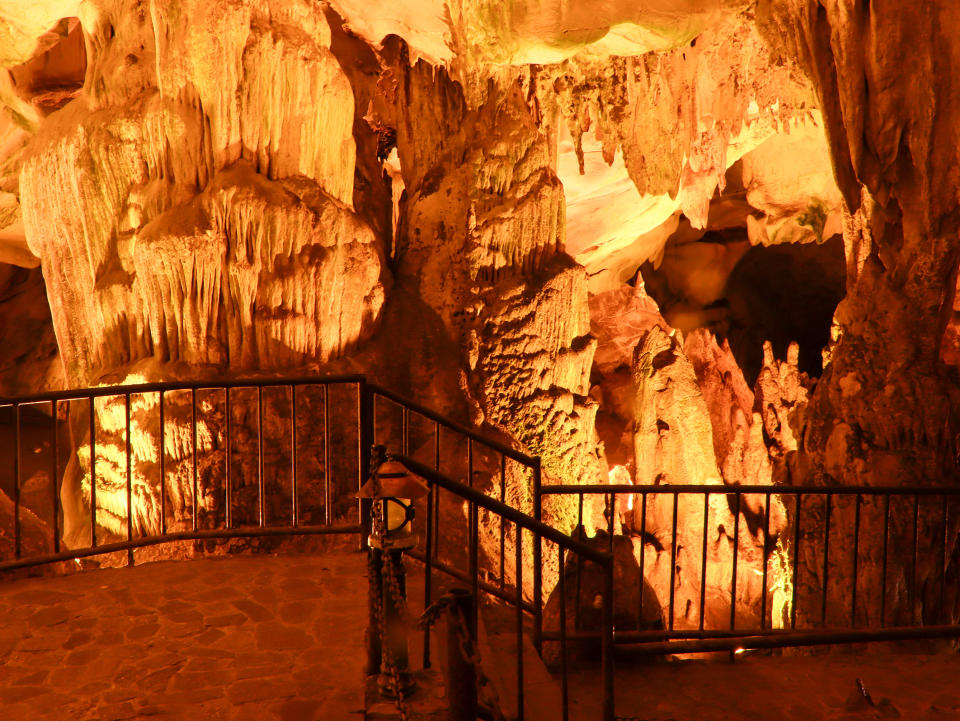 Long exposure stock photo showing stalactites and stalagmites inside a tourist cave open for sightseeing