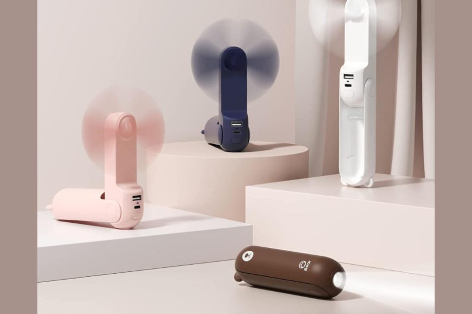 Four handheld fans in different colors.