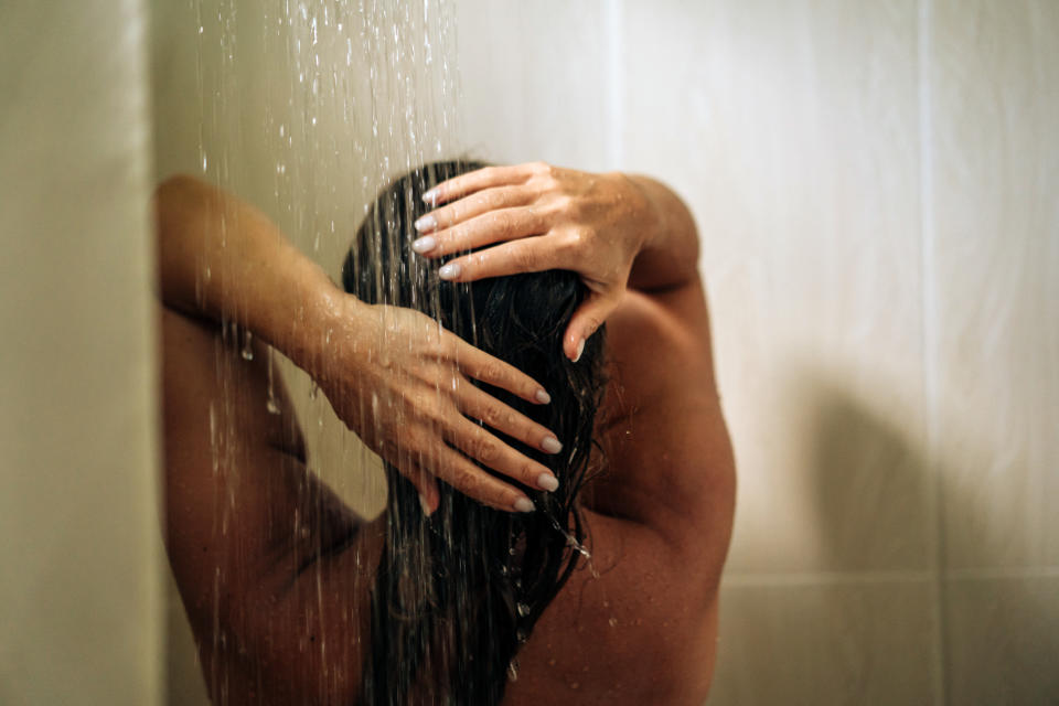 Woman in the hotel room having a shower. Vacation in the tropical resort, morning routine