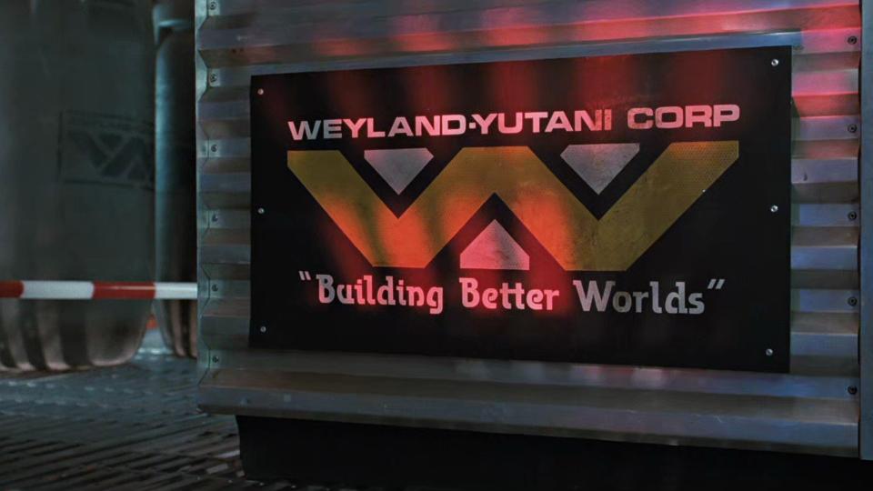  A black sign with yellow printing that reads "weyland-yutani corp" on top. in the middle is a combined yellow 'w' and white 'y'. at the bottom are the words "building better worlds". 