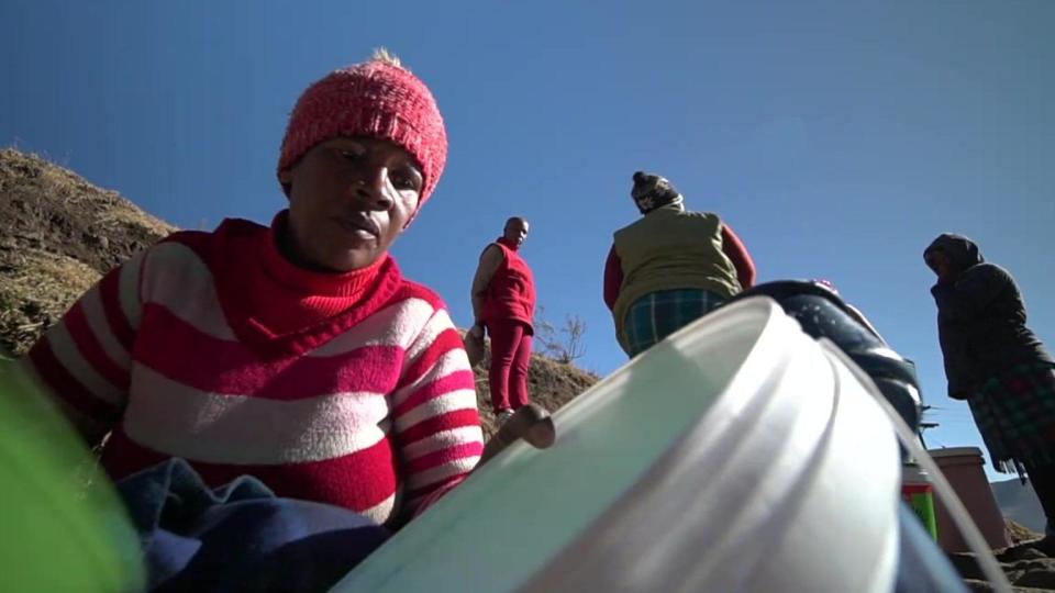 A woman collecting water in a bucket