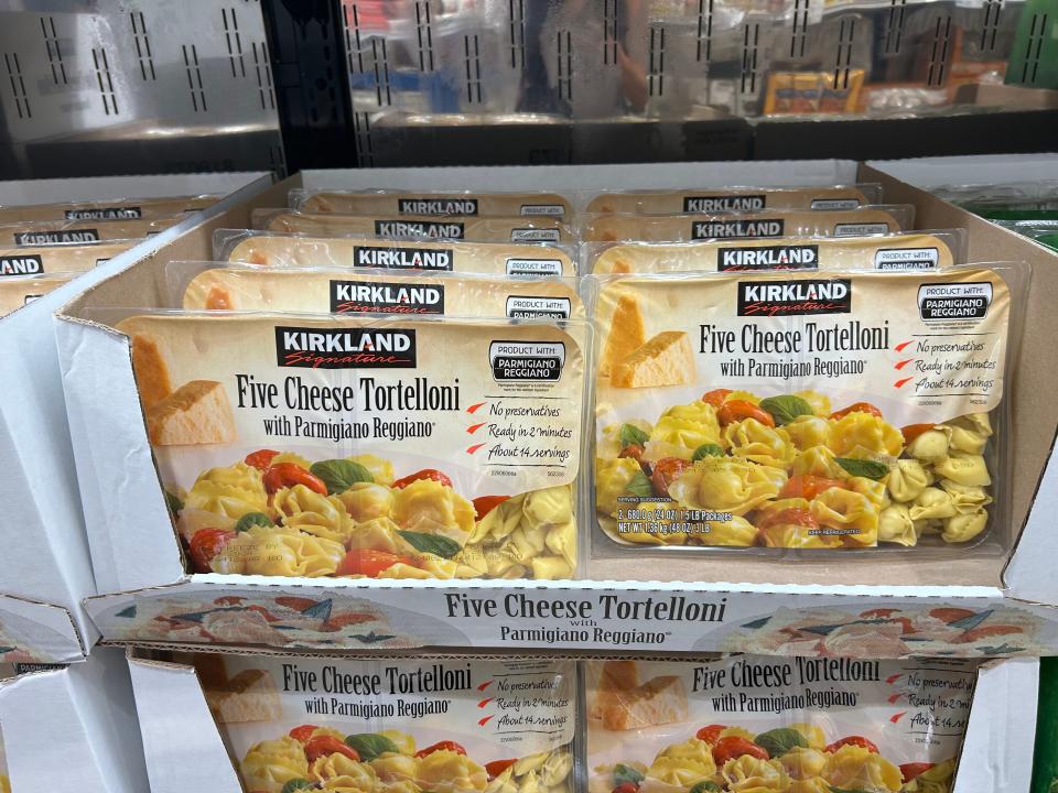 Packs of Kirkland Signature five cheese tortellini on the shelves at Costco.