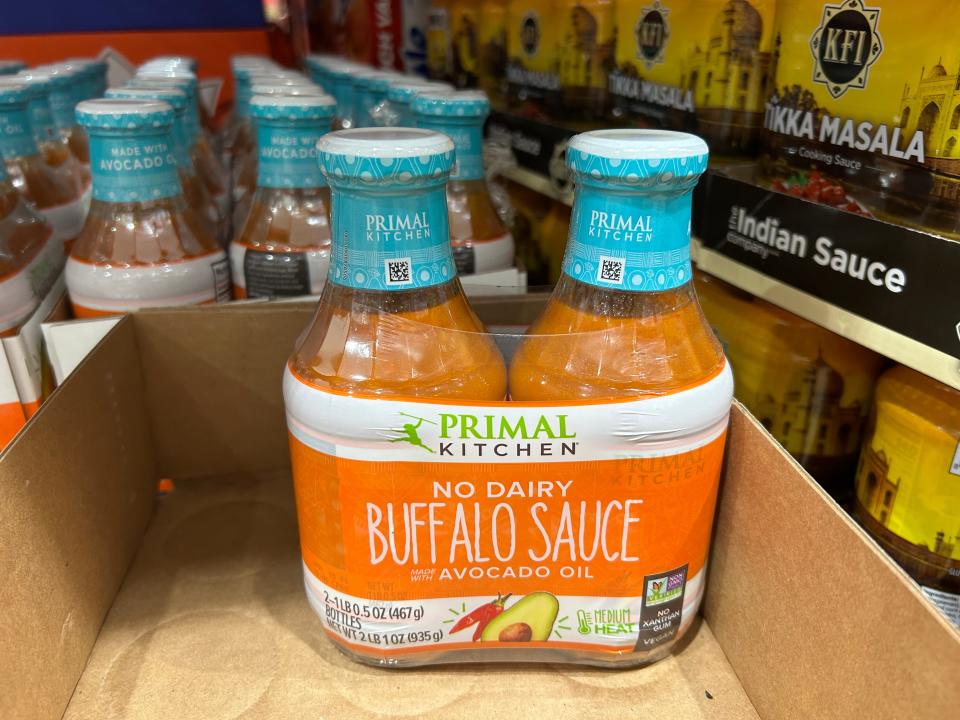 Two bottles of the Primal Kitchen Buffalo sauce packaged together in a box at Costco.