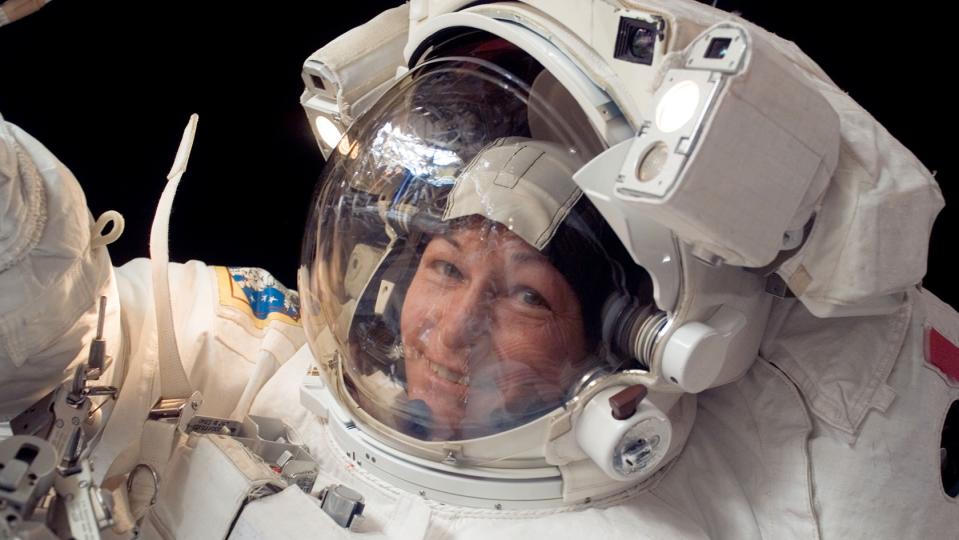 Peggy Whitson in a spacesuit during a spacewalk with face visible behind a clear shield