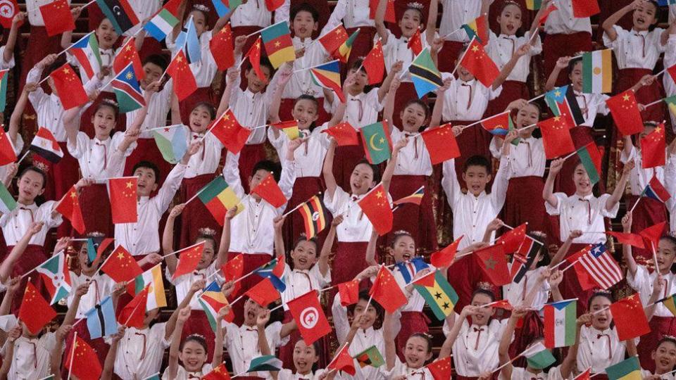 Chinese children holding their countries flag alongside African countries' flags to welcome African leaders to Beijing - Wednesday 4 September 2024