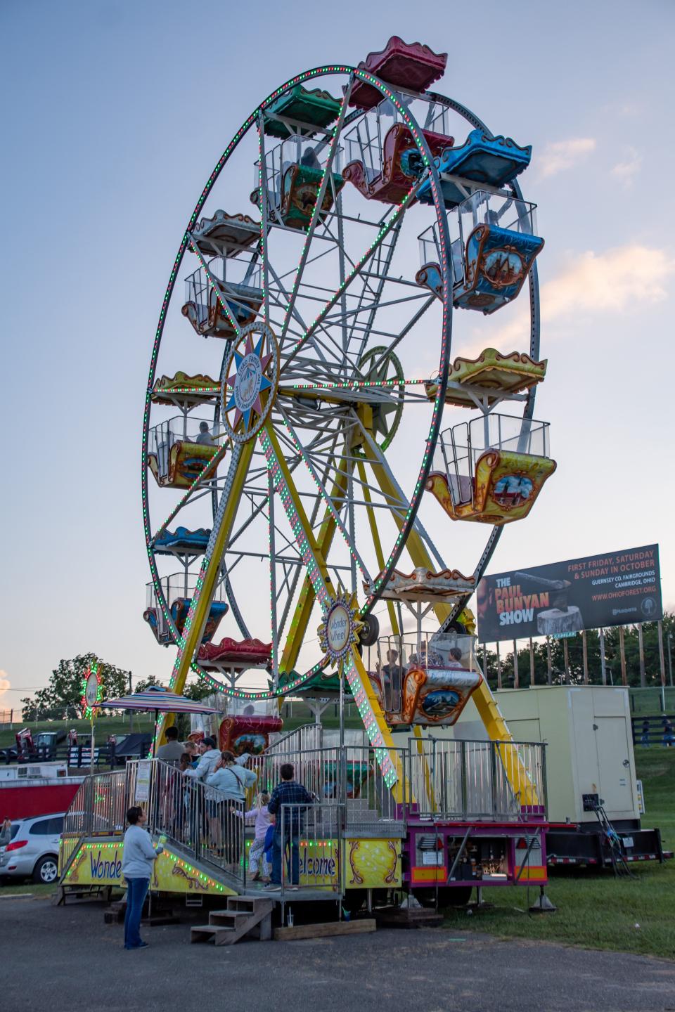 Attendees ride the Ferris wheel at the 2023 fair. f