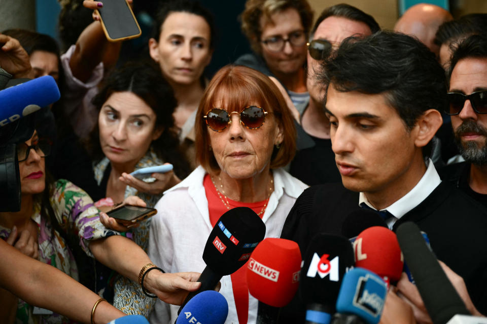 Gisele P. listens to her lawyer Stephane Babonneau addressing media as she leaves the courthouse during the trial of her husband accused of drugging her for nearly ten years and inviting strangers to rape her at their home in Mazan, a small town in the south of France, in Avignon, on September 5, 2024. / Credit: CHRISTOPHE SIMON/AFP via Getty Images