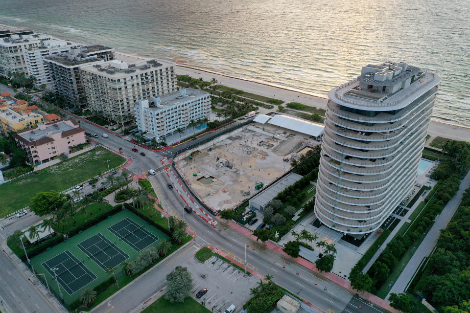 SURFSIDE, FLORIDA - JUNE 22:  In an aerial view, a cleared lot where the 12-story Champlain Towers South condo building once stood is seen on June 22, 2022 in Surfside, Florida. This week marks the first anniversary of the tragic event where 98 people died when the building partially collapsed on June 24, 2021. (Photo by Joe Raedle/Getty Images)