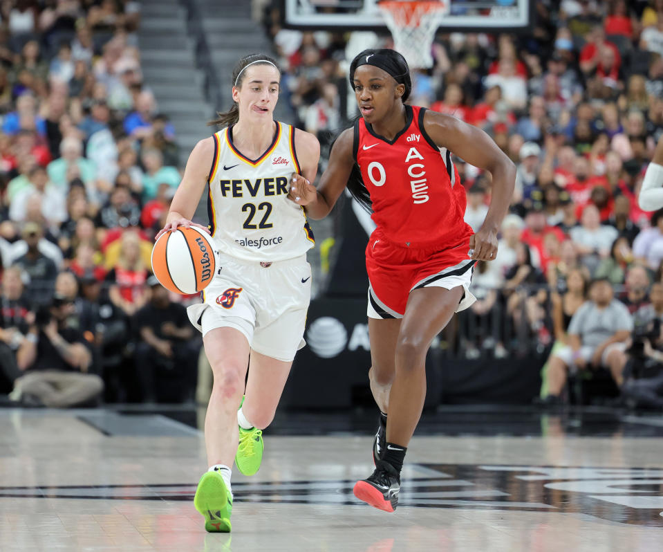 LAS VEGAS, NEVADA - JULY 02: Caitlin Clark #22 of the Indiana Fever brings the ball up the court against Jackie Young #0 of the Las Vegas Aces in the second quarter of their game at T-Mobile Arena on July 02, 2024 in Las Vegas, Nevada. The Aces defeated the Fever 88-69. NOTE TO USER: User expressly acknowledges and agrees that, by downloading and or using this photograph, User is consenting to the terms and conditions of the Getty Images License Agreement. (Photo by Ethan Miller/Getty Images)