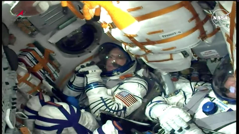 Don Pettit, strapped into the Soyuz spacecraft to the right of commander Aleksey Ovchinin, calmly monitors cockpit displays five minutes before liftoff. / Credit: NASA/Roscosmos