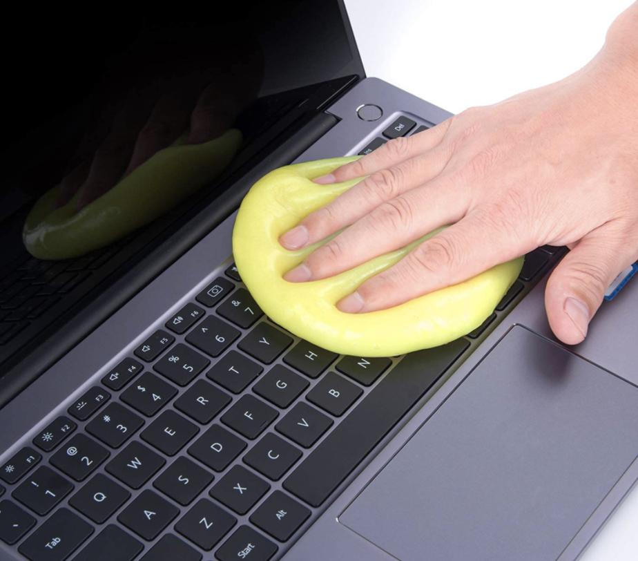 Someone using ColorCoral cleaning gel to clean a keyboard.