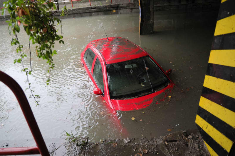 A car stands in the water under a railroad line in a flooded underpass. Heavy continuous rain has led to flood alerts on many rivers and streams in the Czech Republic. The highest warning level 3 ("danger") was in force at more than 25 gauging stations on Saturday morning. Water levels are expected to rise further over the weekend. Sznapka Petr/CTK/dpa