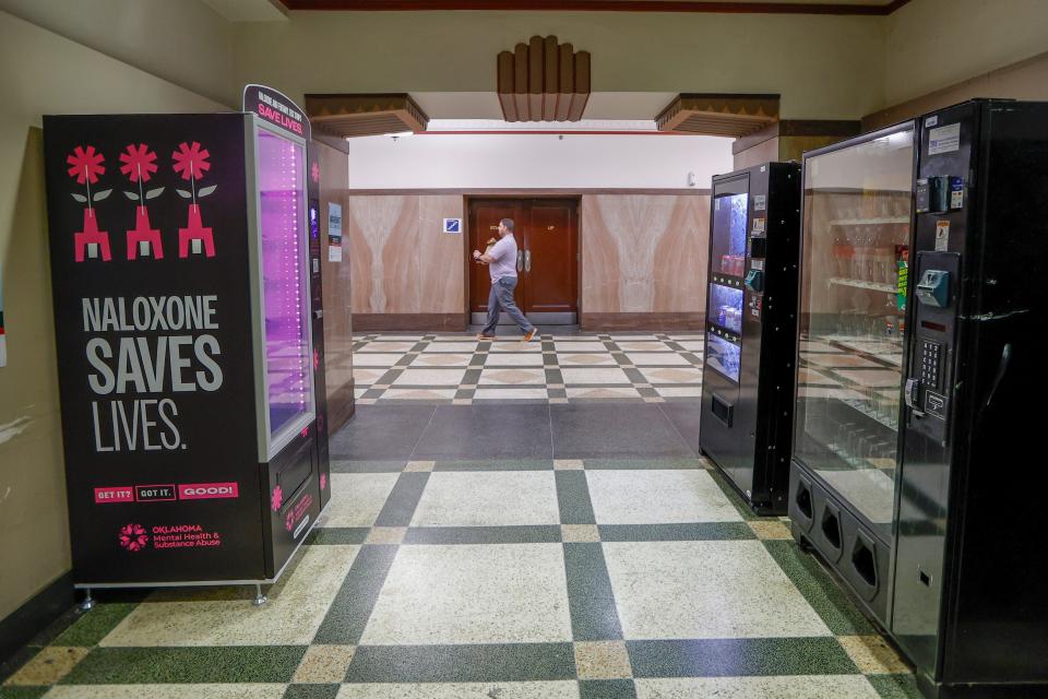 A person walks past a Naloxone vending machine inside Oklahoma County's courthouse in Oklahoma City, Thursday, Dec. 14, 2023.